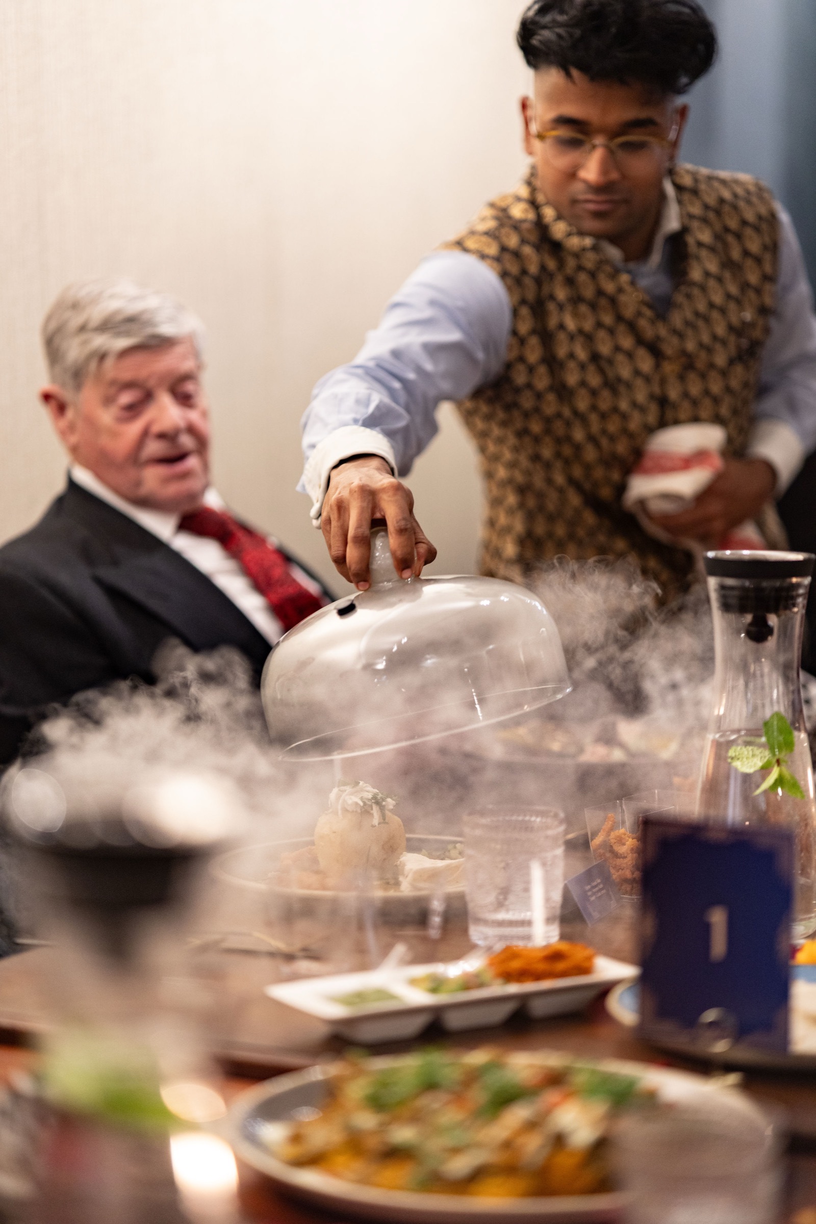 Founder Mahésh presenting a course tableside at a Késarum private dining event in Southampton