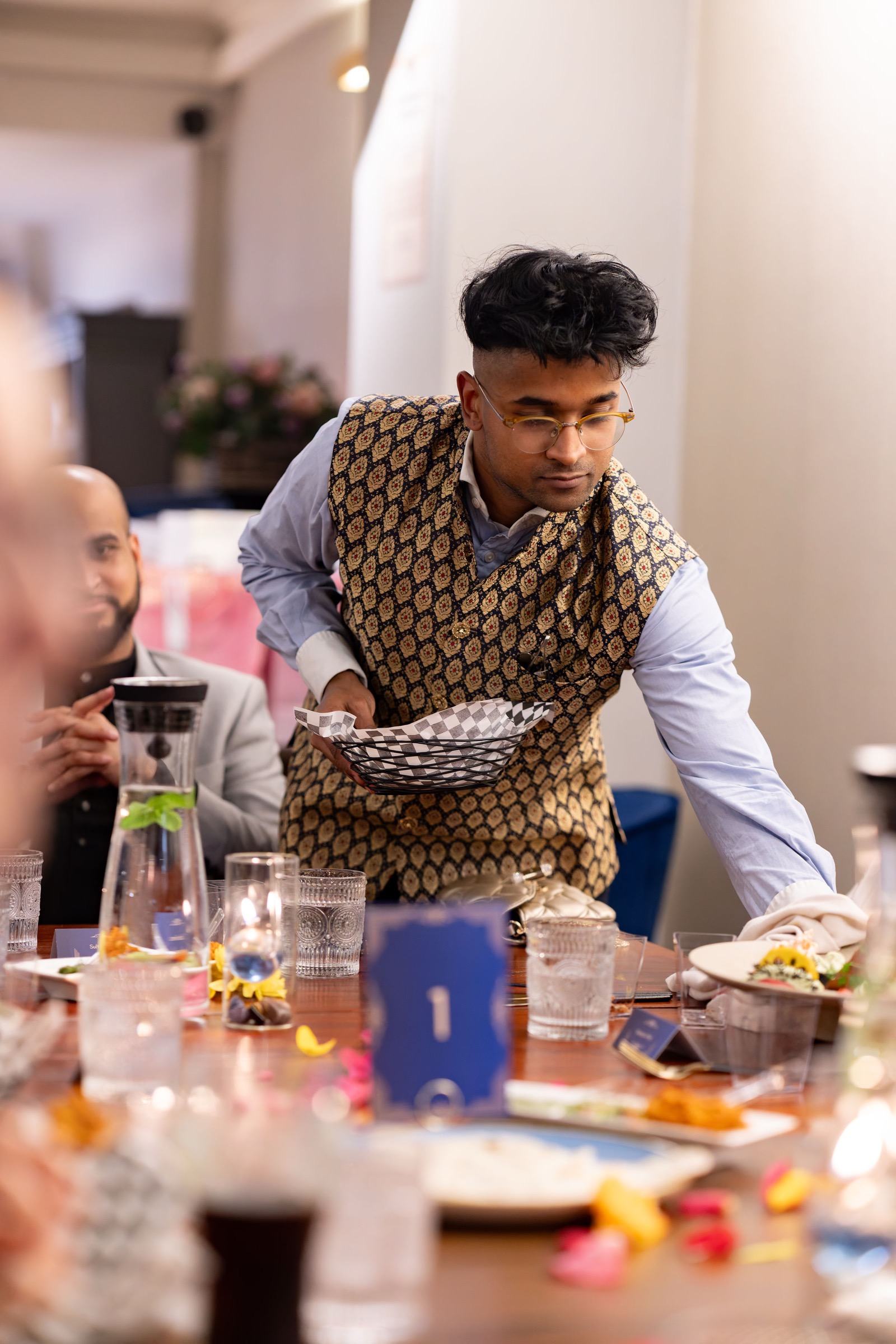 Founder Mahésh attending guests at a private table at Késarum, Southampton
