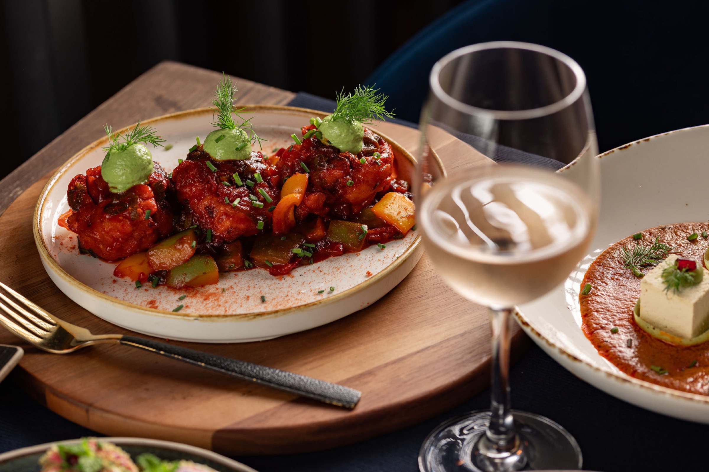 Wine alongside a spread of plant-based Indian dishes at Késarum, Southampton